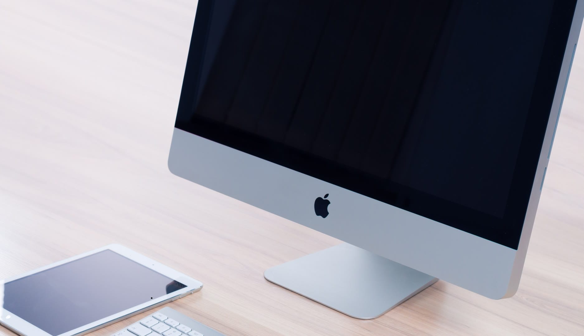 Web designer working on a creative and responsive website layout on a desktop computer with various design tools