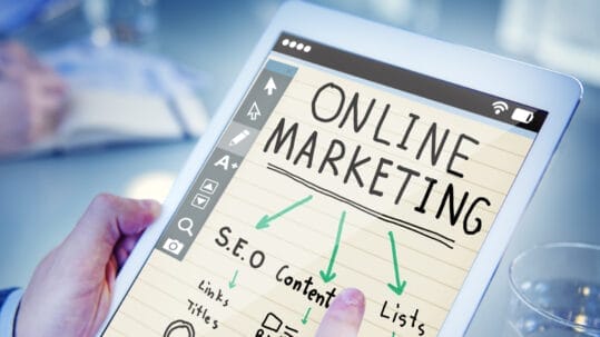 A digital marketing team working on search engine optimization strategies on a computer, showcasing Naples' vibrant business environment.