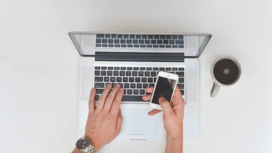 A graphic showing a web designer optimizing a client's website performance on a laptop, symbolizing digital marketing services in Naples, Florida
